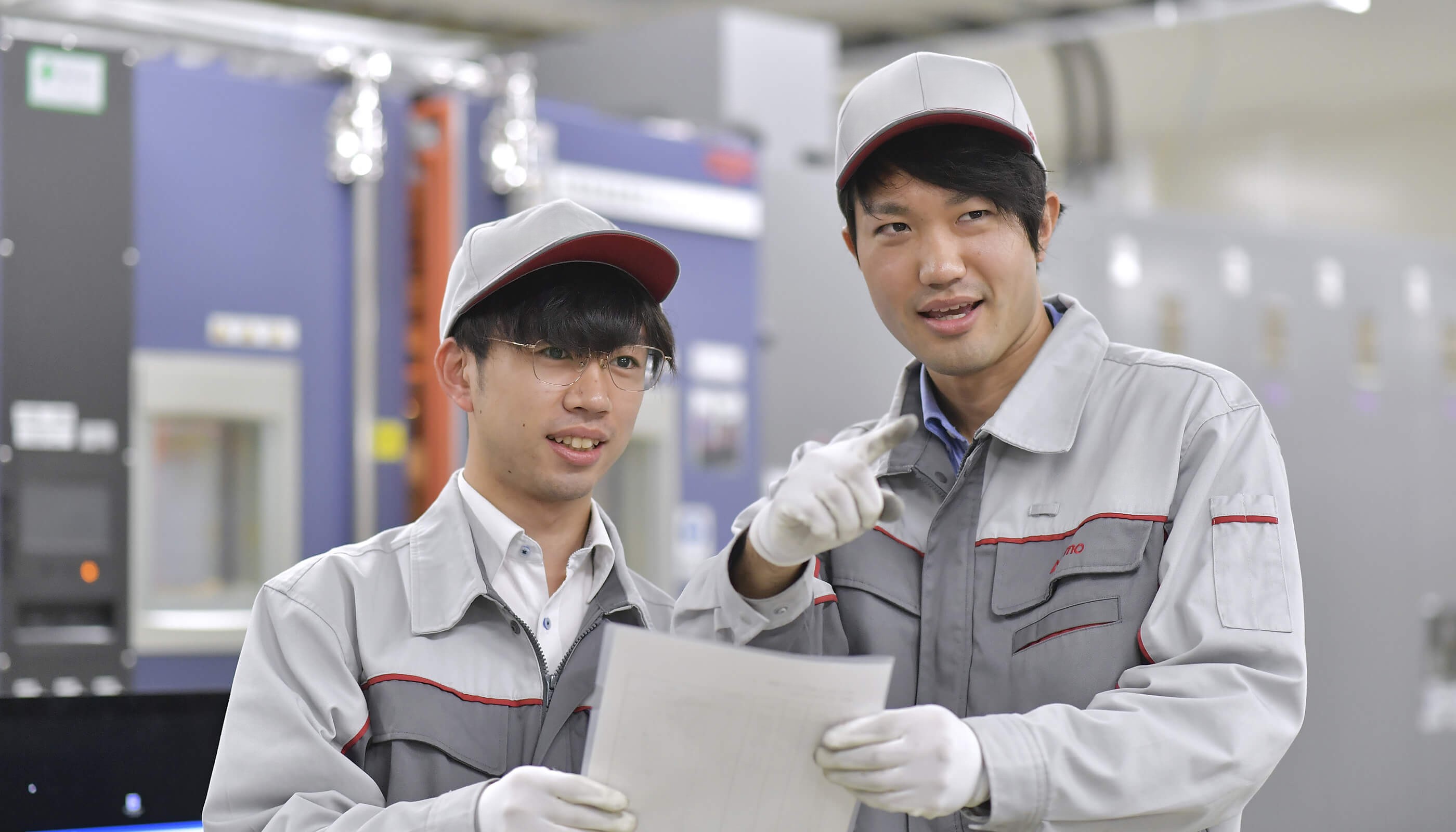 two men wearing white caps and gloves holding a piece of paper