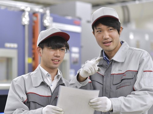 two men wearing white caps and gloves holding a piece of paper
