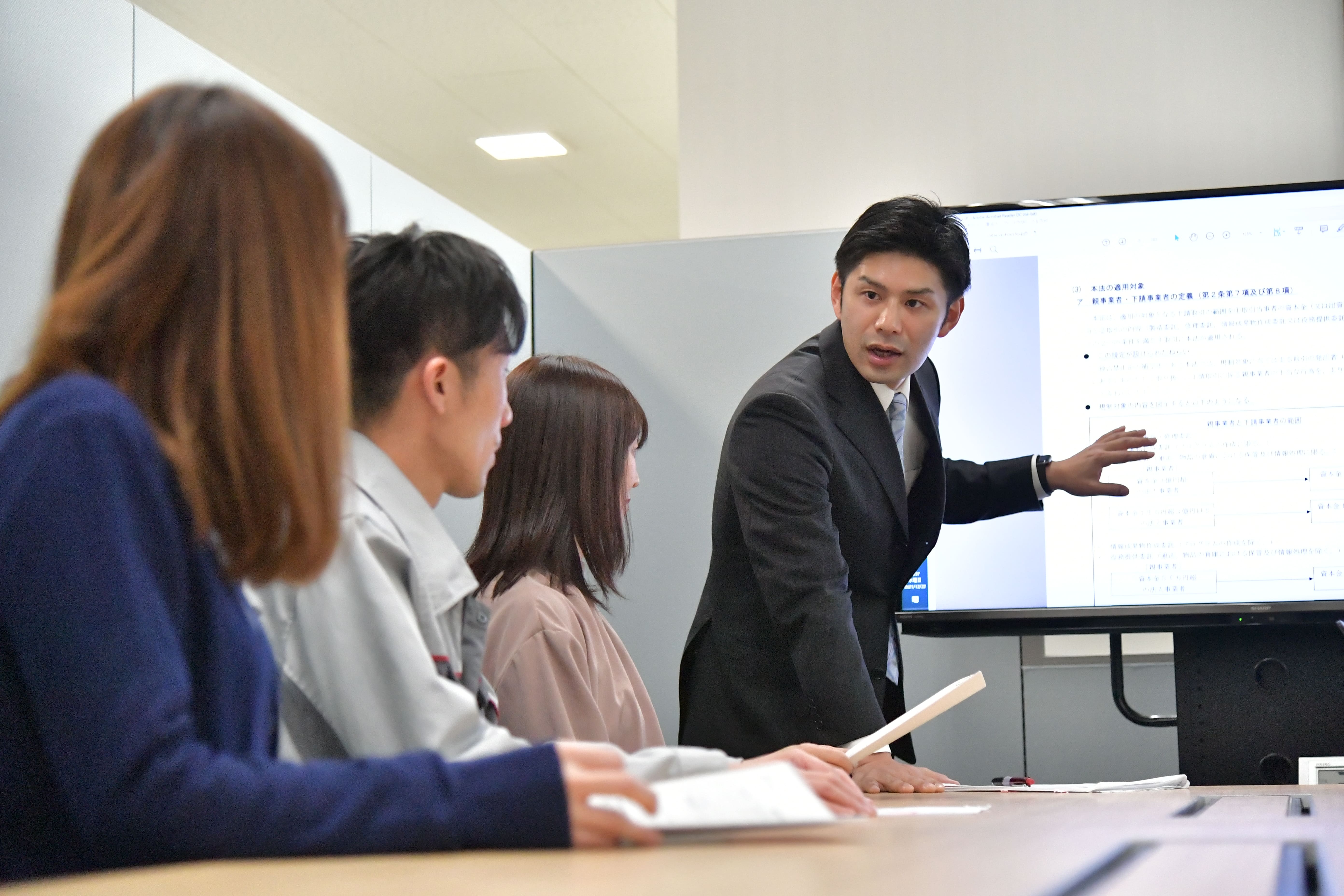 a person standing in front of a screen