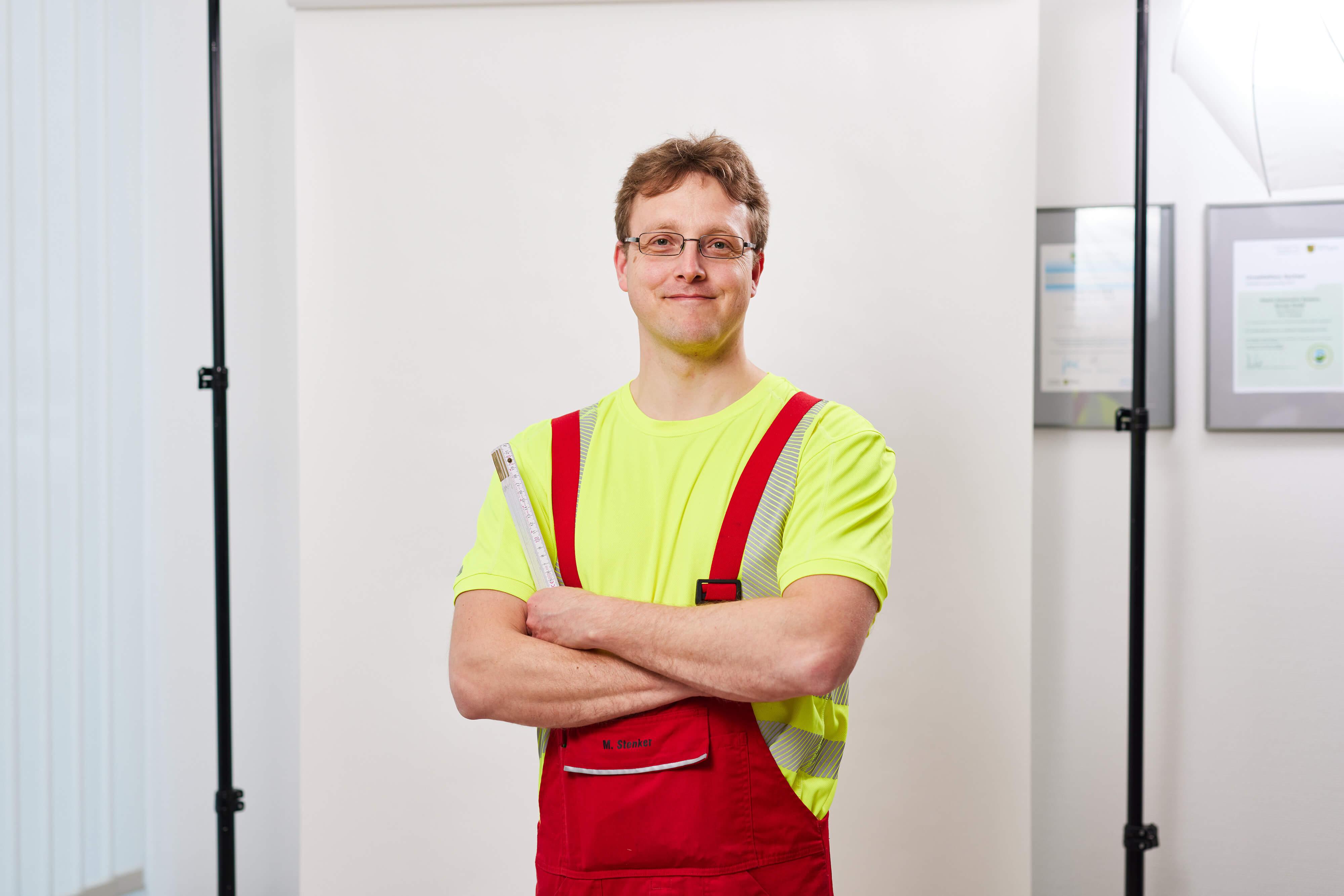 a person in a yellow shirt and red overalls
