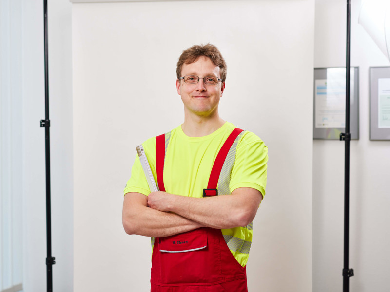 a person in a yellow shirt and red overalls