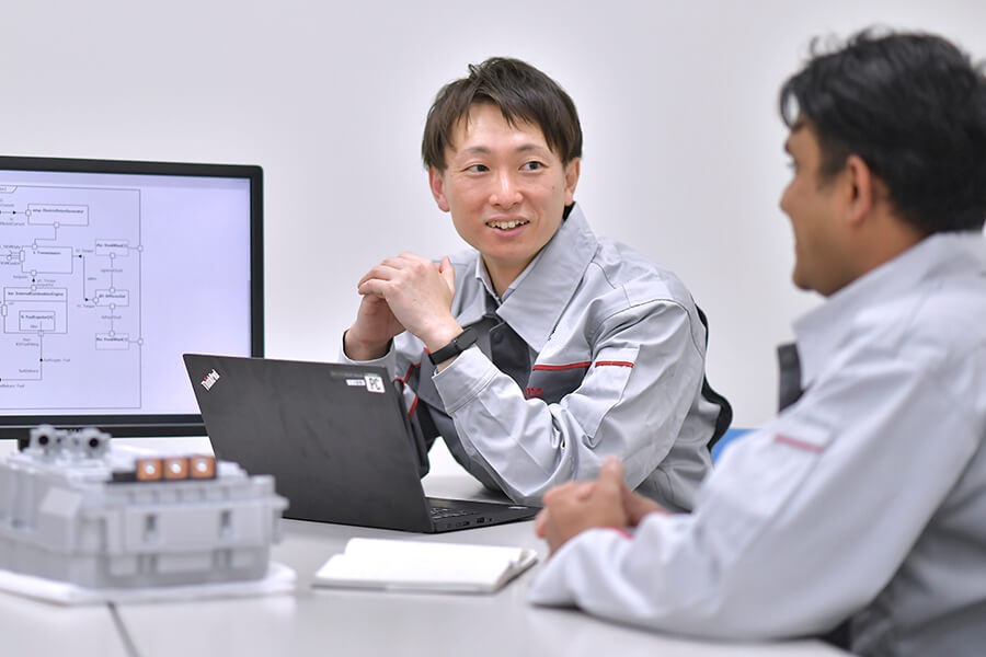 ノートパソコンを持ってテーブルに座っている人