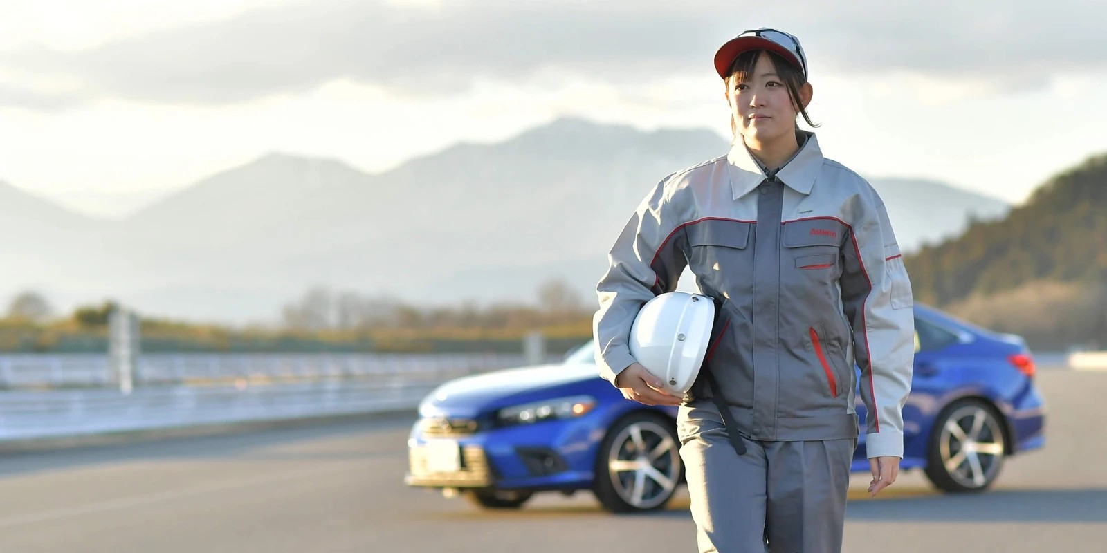 a person wearing a helmet and holding a helmet