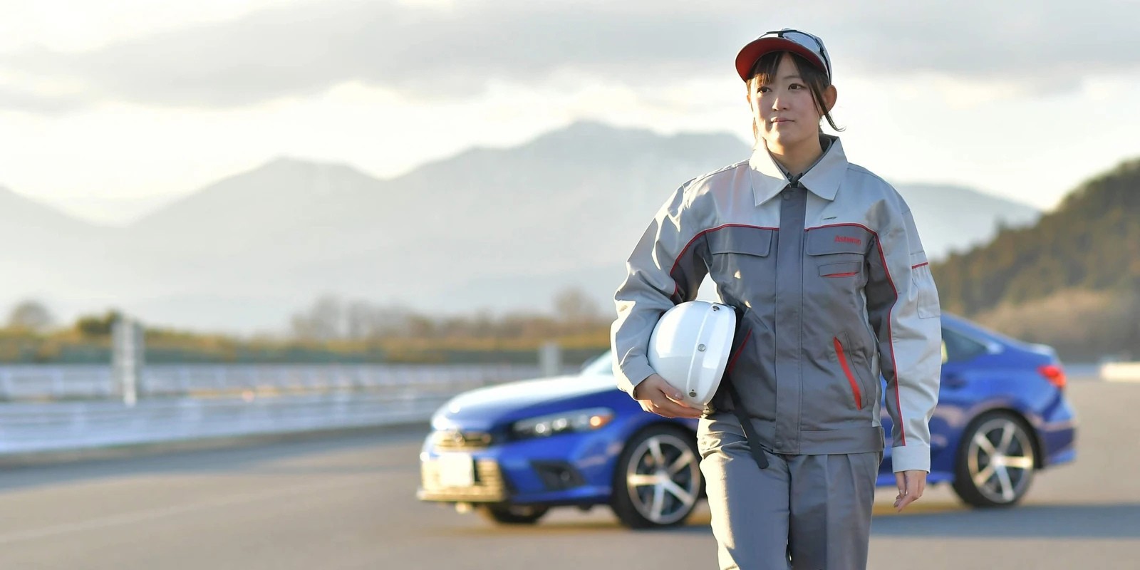 a person wearing a helmet and holding a helmet