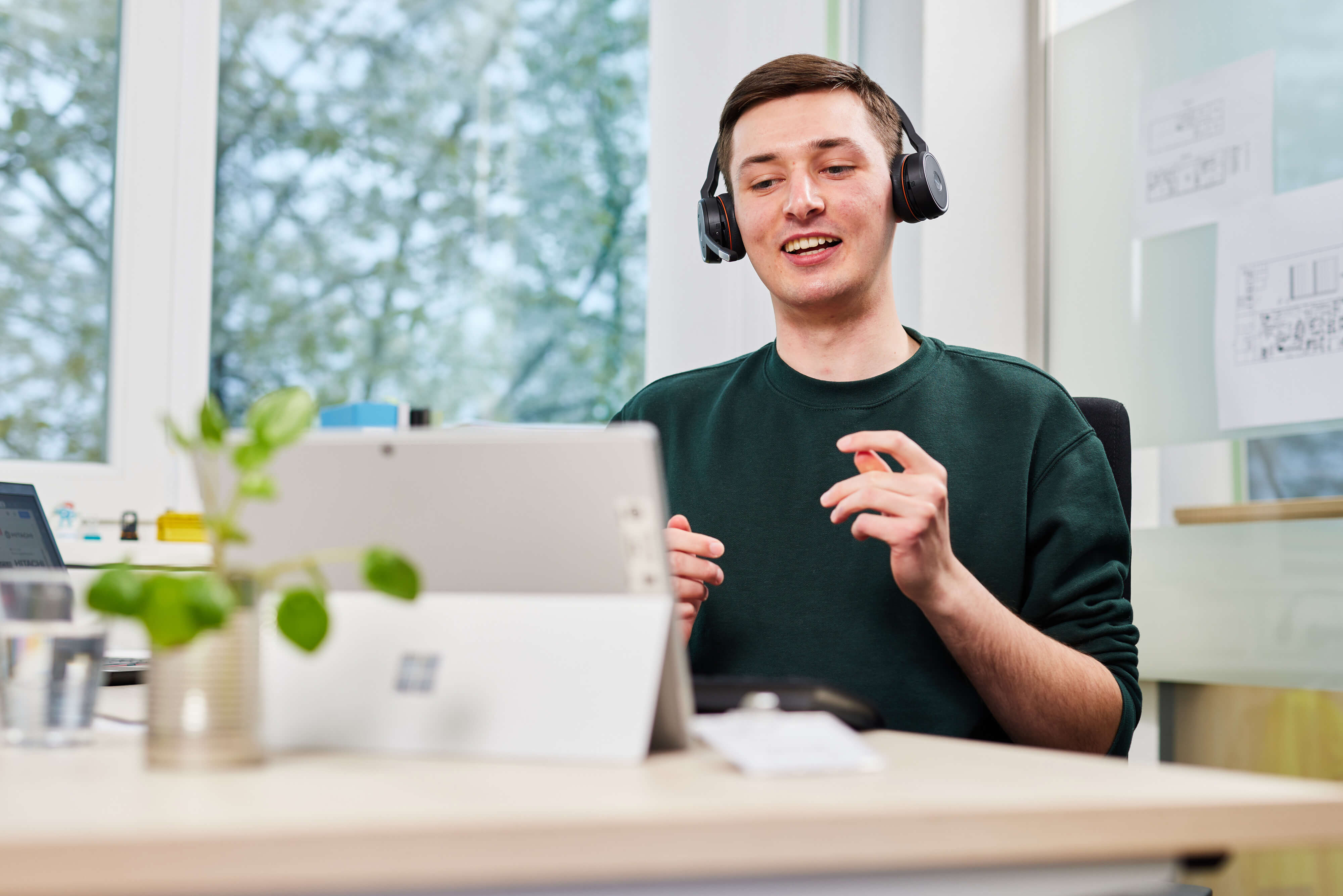 a person wearing headphones and sitting at a desk