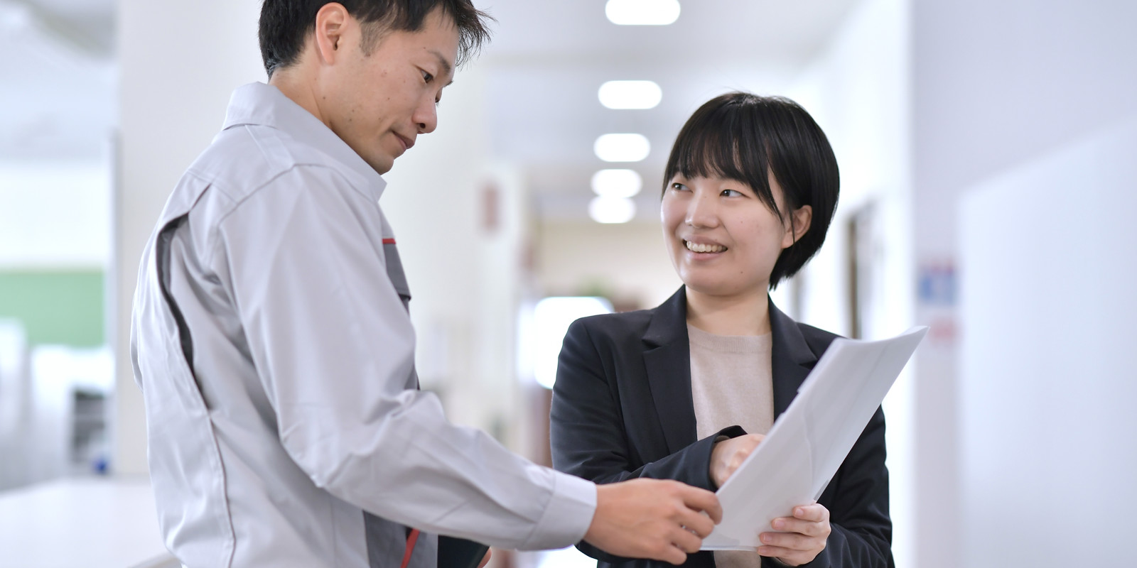 a person and person looking at paper