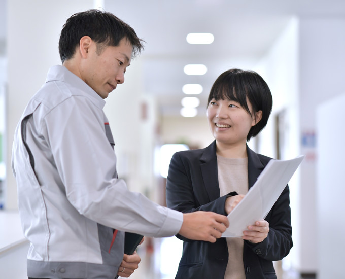a person and person looking at paper