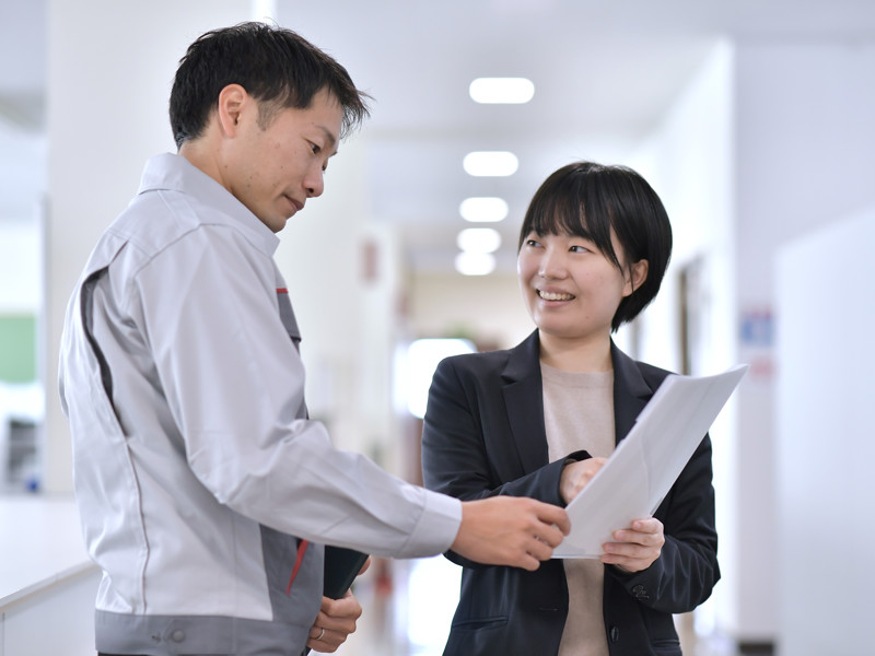 a person and person looking at paper