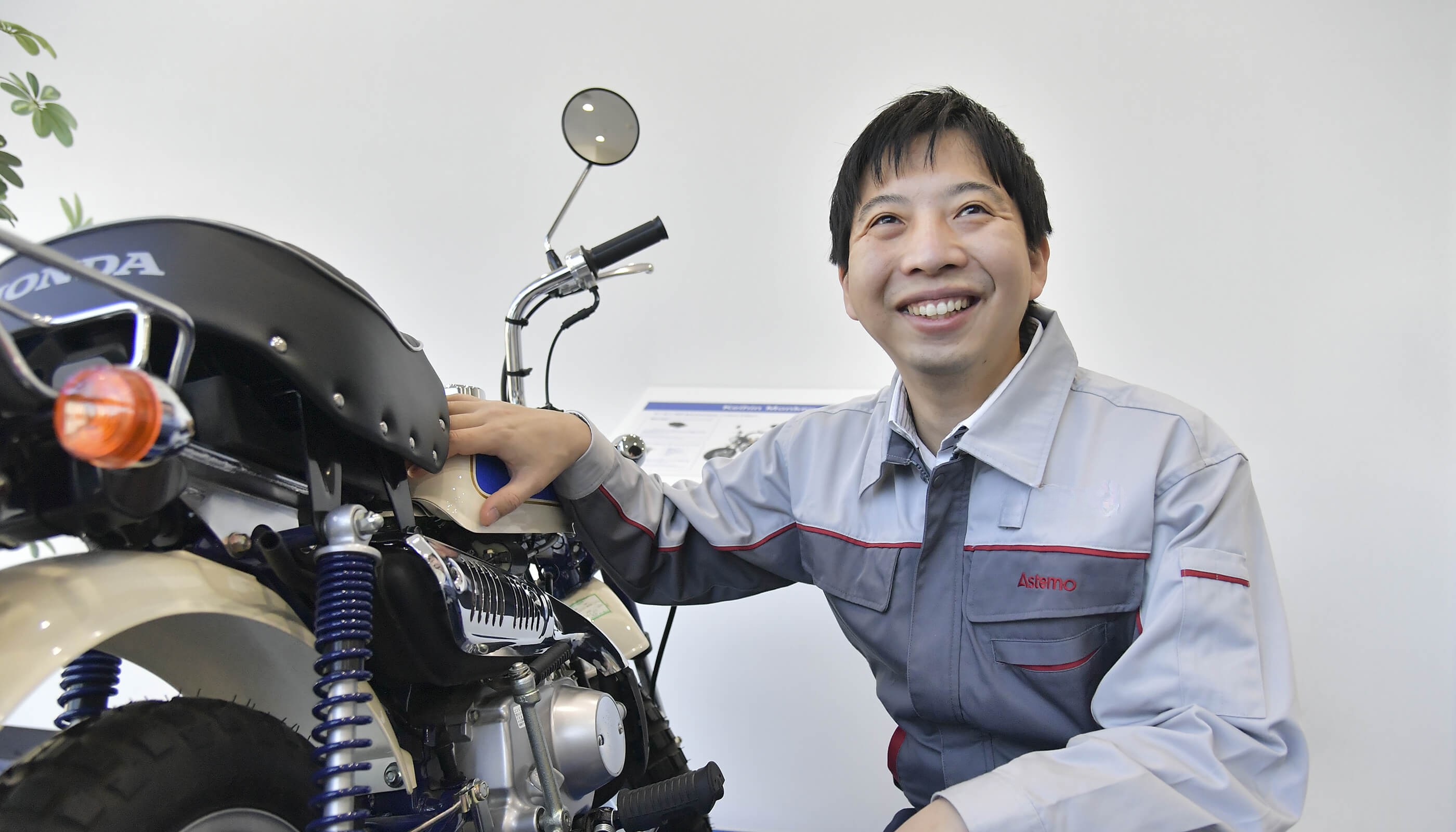 a person smiling at a motorcycle