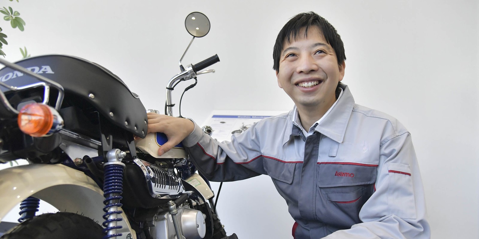a person smiling at a motorcycle