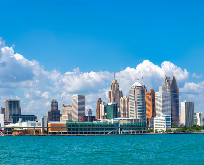 a city skyline with a body of water