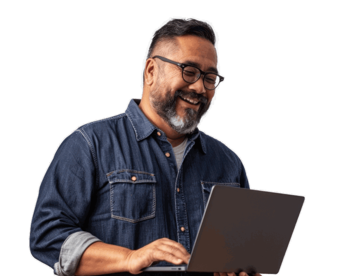 a person smiling while holding a laptop