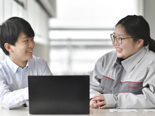 a person and person looking at a laptop