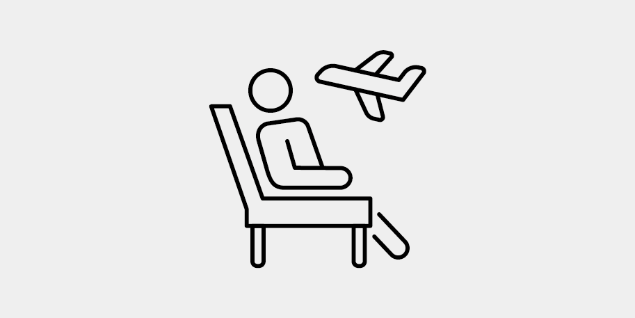 a person sitting in a chair with an airplane flying above