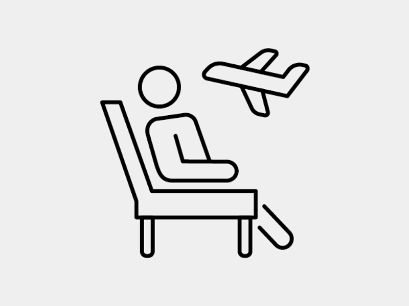 a person sitting in a chair with an airplane flying above