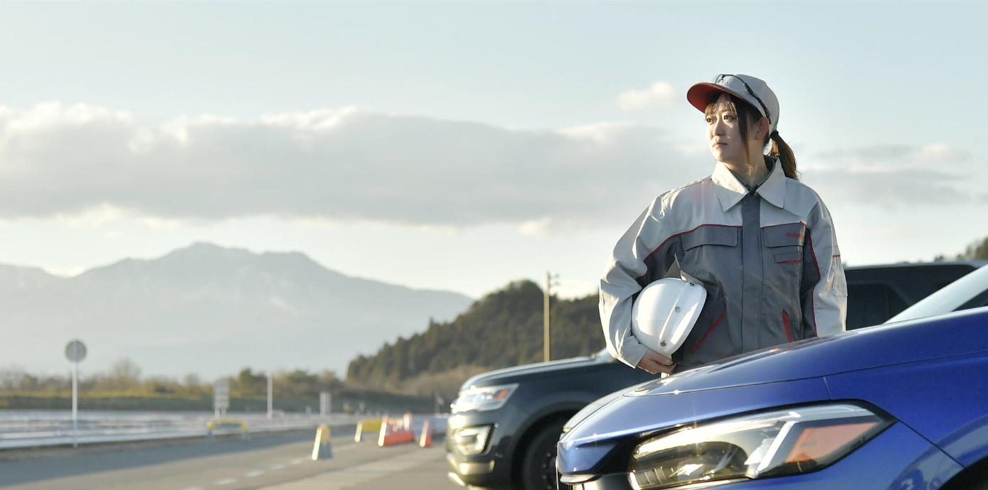 a person holding a helmet on a car