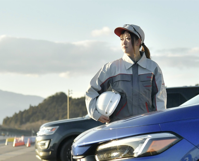 a person holding a helmet on a car