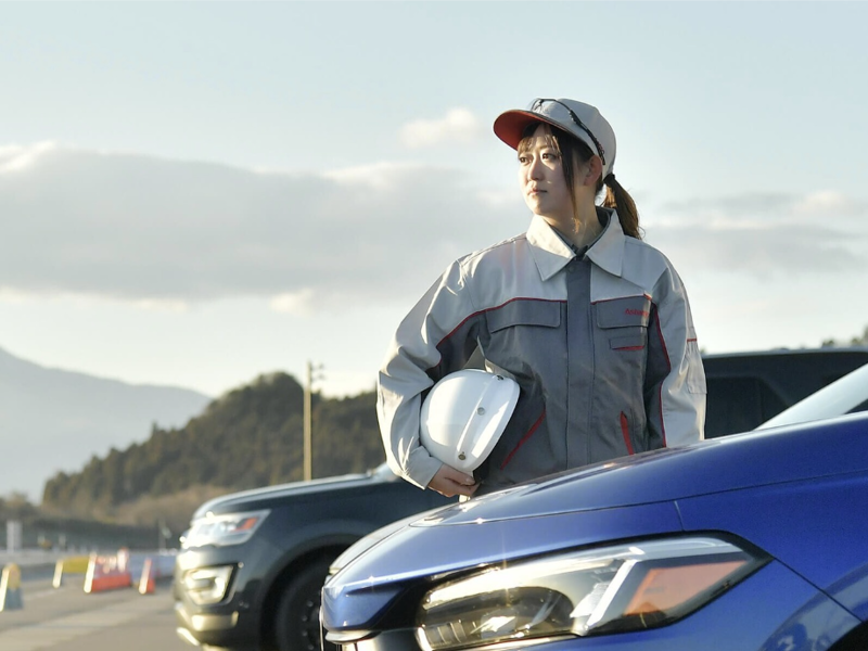 a person holding a helmet on a car