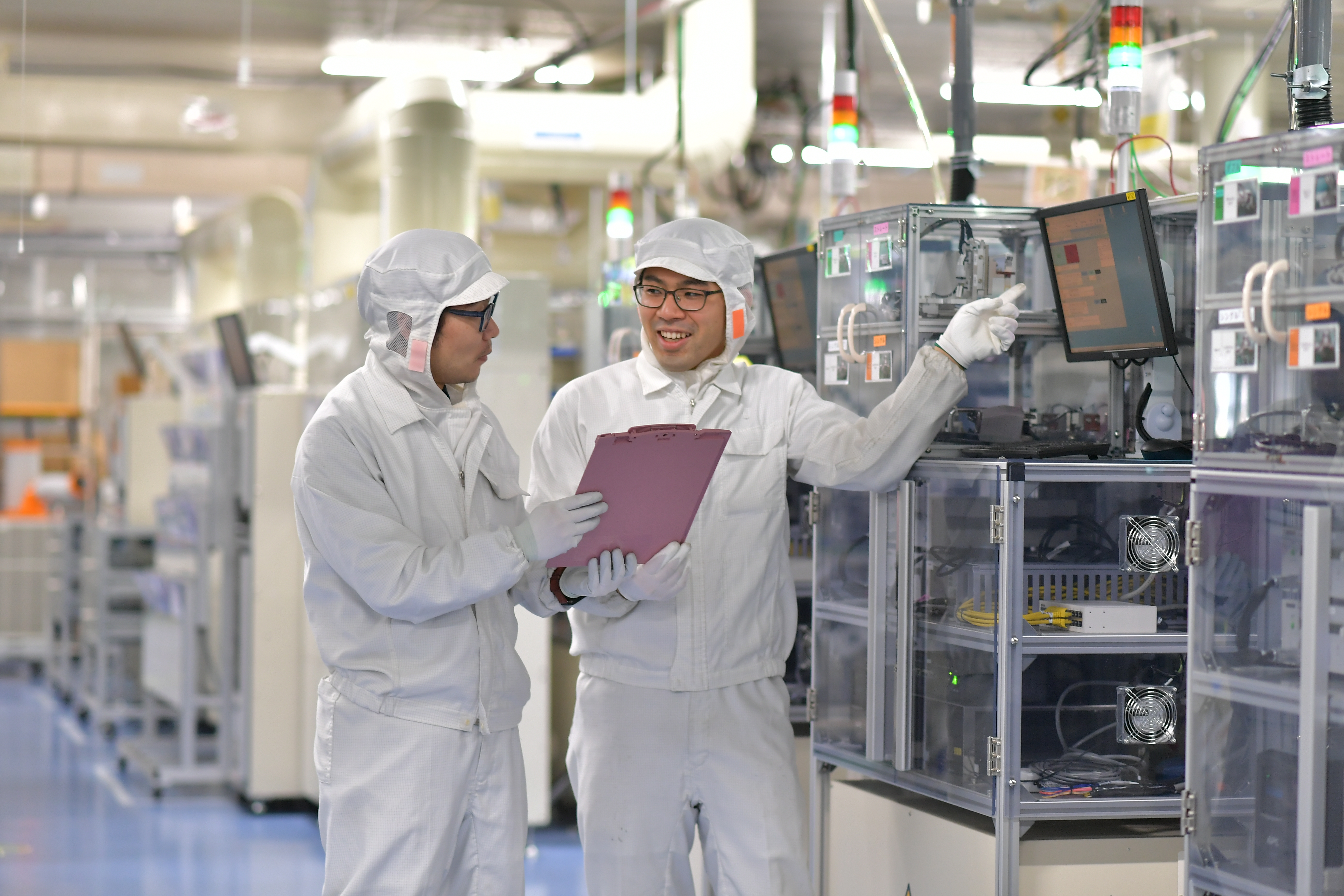 a couple of men in white protective suits