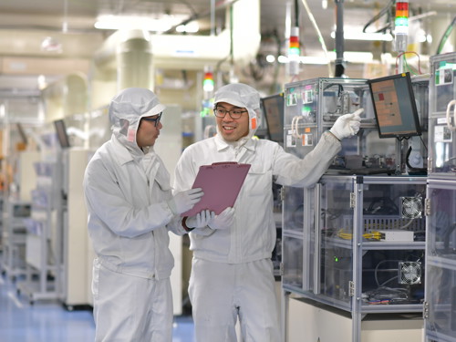 a couple of men in white protective suits