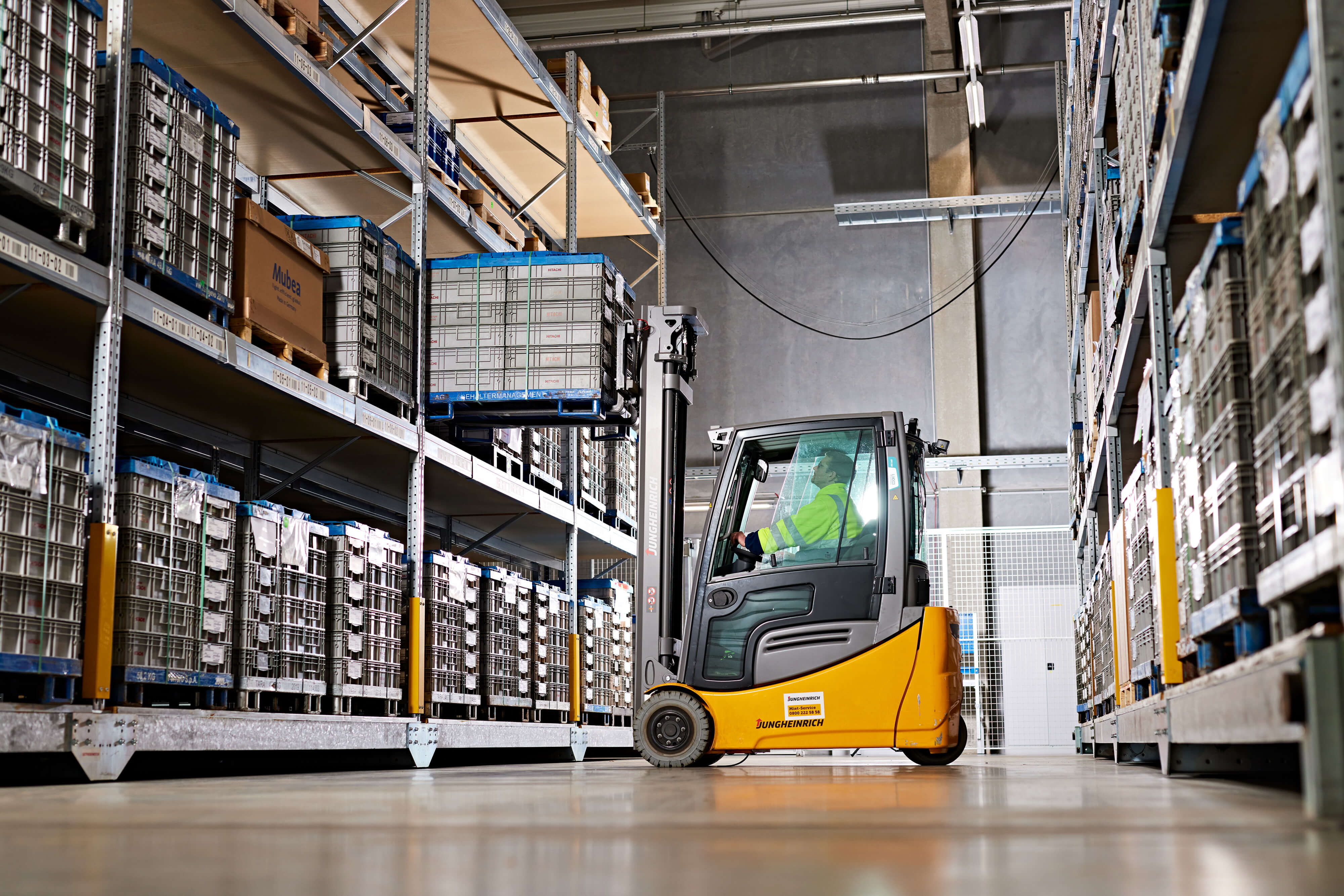a person driving a forklift in a warehouse