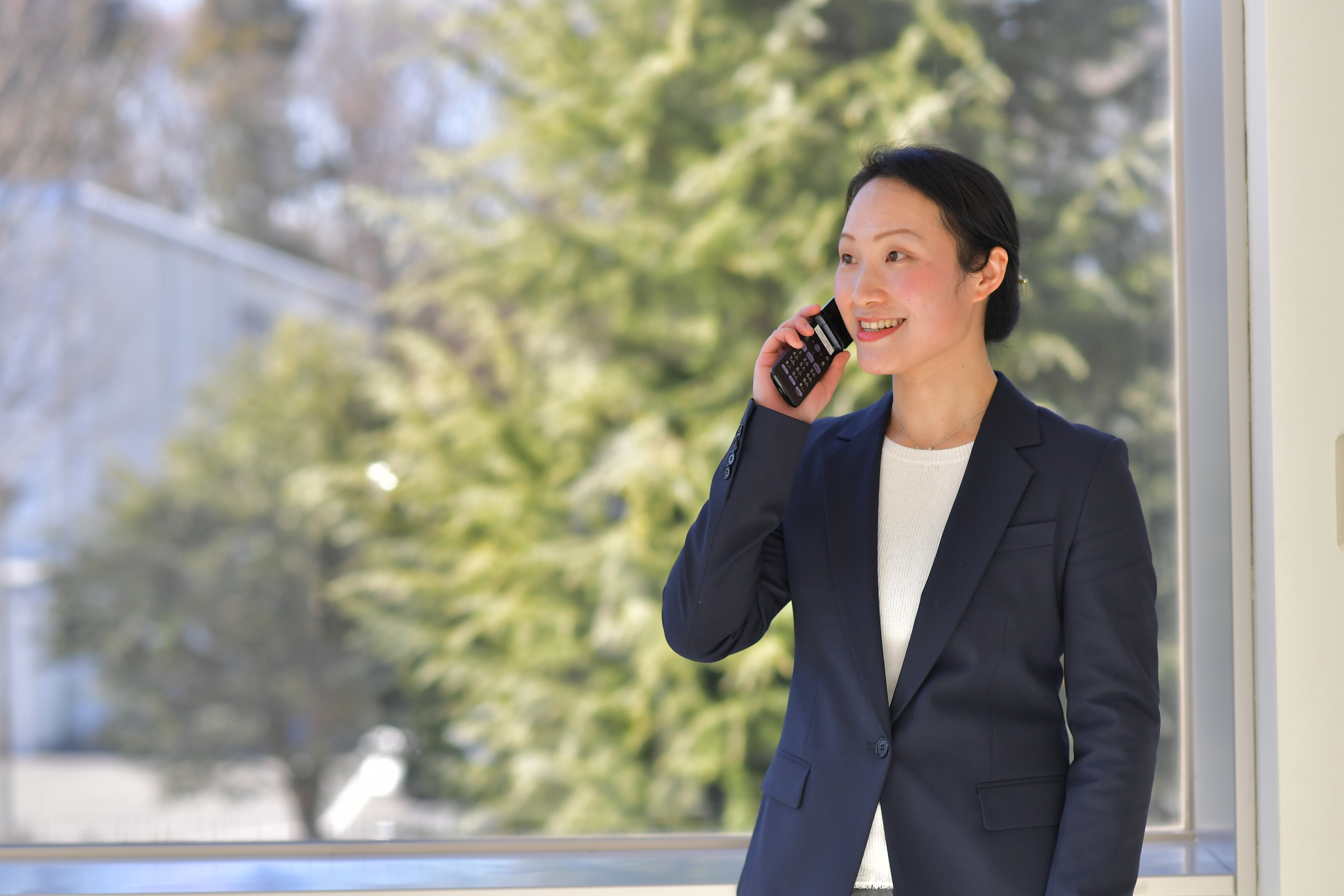 a person in a suit talking on a cell phone