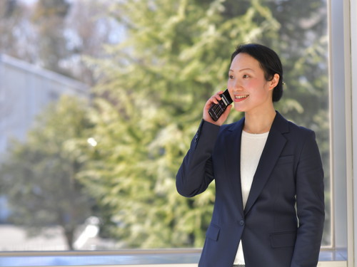 a person in a suit talking on a cell phone